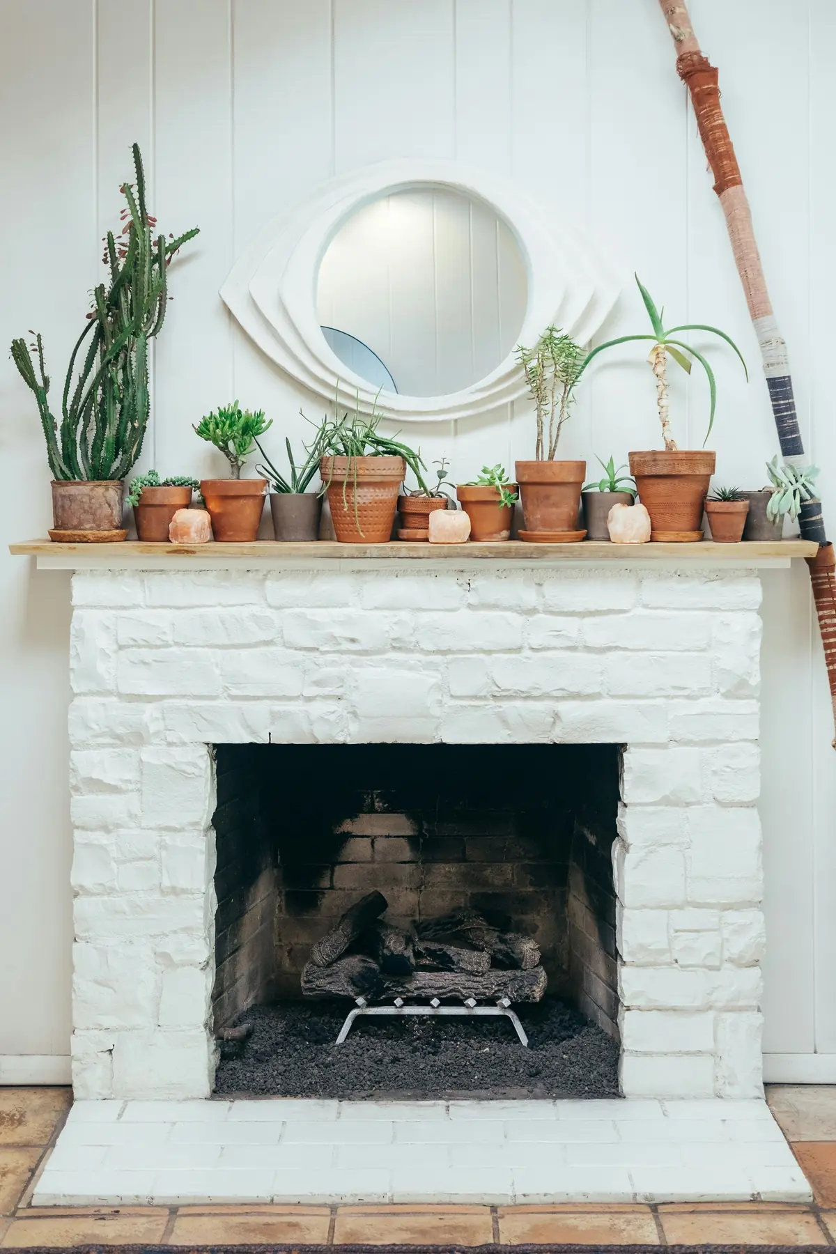 A white brick fireplace that is not currently lit